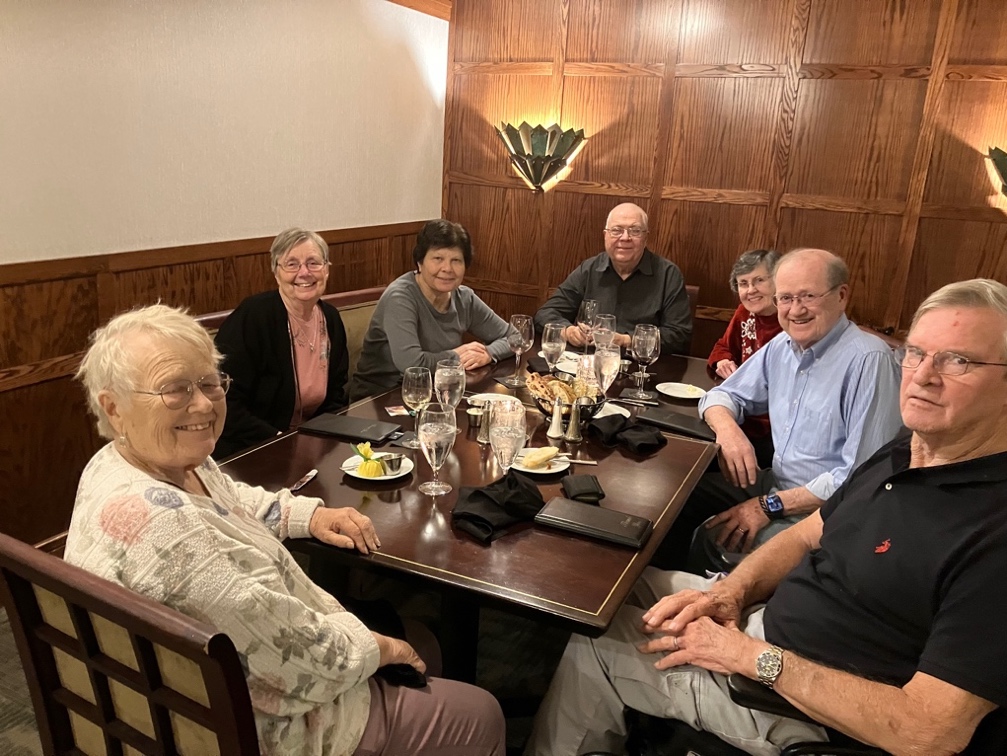 A group of people sitting around a table

Description automatically generated