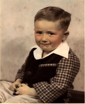 A young child in a suit

Description automatically generated